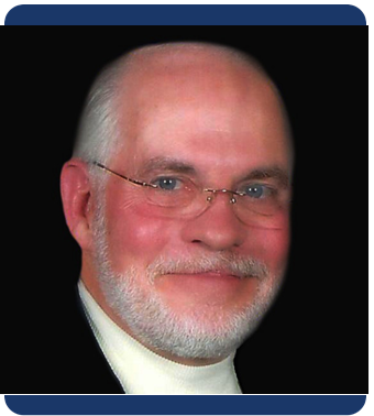 A professional headshot of an older man with a bald head, glasses, and a neatly trimmed white beard. He is smiling slightly and wearing a light shirt under a dark jacket. The background is black, and the image is framed with a rounded navy border.
