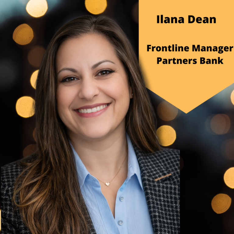 A professional headshot of Ilana Dean smiling, with long dark brown hair, wearing a light blue blouse and patterned blazer. The background has soft gold lights. Text on the image reads Ilana Dean, Frontline Manager, Partners Bank.