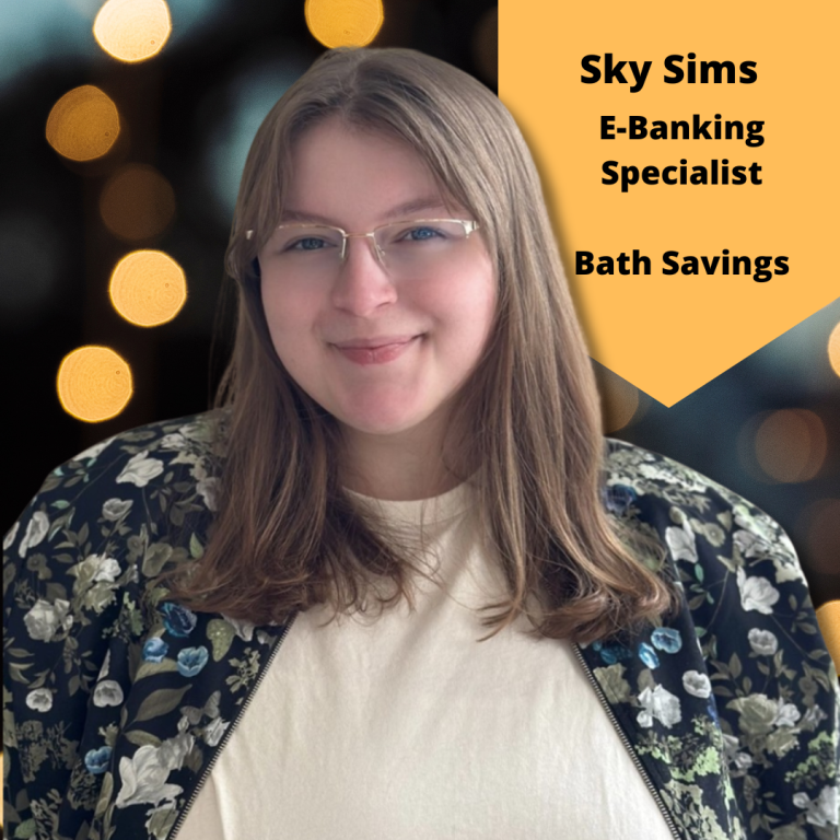 Portrait of Sky Sims, E-Banking Specialist at Bath Savings, smiling and wearing glasses and a floral jacket against a soft bokeh light background, with name and title displayed on a gold banner.