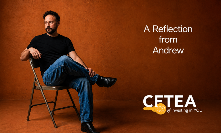 Andrew dressed in a black T shirt, blue jeans, and black boots sits on a folding chair against a warm rust colored backdrop, gazing off to the side in quiet reflection. White text on the right reads, "A Reflection from Andrew." The lower right corner features the CFTEA logo with a gold key celebrating "100 Years" and the tagline, "of Investing in YOU." The wide banner design uses generous open space to create a calm, reflective atmosphere.